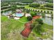 Aerial view of community amenities with pool, tennis courts, sand volleyball, basketball court, and playground at 3718 Beneraid St, Land O Lakes, FL 34638