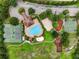 Aerial view of community amenities including a swimming pool, playground, tennis court, and basketball court at 3718 Beneraid St, Land O Lakes, FL 34638