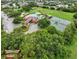 Overhead shot highlighting the community pool, lounge area, and tennis courts with lush landscaping at 3718 Beneraid St, Land O Lakes, FL 34638