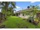 A lush backyard with mature landscaping and an enclosed patio, offering a serene outdoor living space at 3718 Beneraid St, Land O Lakes, FL 34638