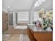 Bathroom featuring a soaking tub, glass-enclosed shower, and bright lighting at 3718 Beneraid St, Land O Lakes, FL 34638