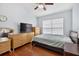 Cozy bedroom featuring hardwood floors, a ceiling fan, and neutral decor, creating a relaxing retreat at 3718 Beneraid St, Land O Lakes, FL 34638