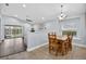 Bright dining area with a wooden table and chairs, tile floor, and natural light at 3718 Beneraid St, Land O Lakes, FL 34638