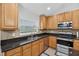 Well-equipped kitchen featuring stainless steel appliances and granite countertops at 3718 Beneraid St, Land O Lakes, FL 34638