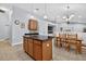 Lovely kitchen with a dark countertop island, wooden cabinets, and tile flooring at 3718 Beneraid St, Land O Lakes, FL 34638