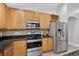 Kitchen with sleek appliances, black countertops, and a stylish backsplash at 3718 Beneraid St, Land O Lakes, FL 34638