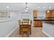 Bright eat-in kitchen features modern cabinets, granite countertops, and a dining table at 3718 Beneraid St, Land O Lakes, FL 34638