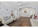 Spacious living room featuring hardwood floors, comfortable seating, and open layout at 3718 Beneraid St, Land O Lakes, FL 34638