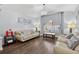 Living room showcasing hardwood floors, plenty of natural light, and vaulted ceilings at 3718 Beneraid St, Land O Lakes, FL 34638