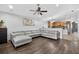 Spacious living room with a large gray couch, wood floors, and modern decor at 3718 Beneraid St, Land O Lakes, FL 34638