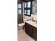 Bathroom showcasing a dark vanity, toilet, shower with glass doors, and neutral-toned design at 401 Fern Cliff Ave, Temple Terrace, FL 33617
