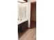 Bathroom featuring a single vanity, neutral countertops and wood-style floors, adjacent to the closet at 401 Fern Cliff Ave, Temple Terrace, FL 33617