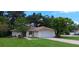 Charming single-story home featuring a well-maintained lawn and an attached two-car garage at 401 Fern Cliff Ave, Temple Terrace, FL 33617