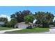 Single-story home with a classic design, surrounded by lush greenery and mature trees at 401 Fern Cliff Ave, Temple Terrace, FL 33617