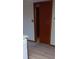 View of the doorway, leading to adjacent room with vinyl flooring, showcasing seamless flow at 401 Fern Cliff Ave, Temple Terrace, FL 33617