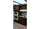 Well-lit kitchen with wood cabinets, featuring modern appliances and ample countertop space at 401 Fern Cliff Ave, Temple Terrace, FL 33617