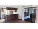 Open kitchen with wood cabinets, a breakfast bar, and access to a screened patio at 401 Fern Cliff Ave, Temple Terrace, FL 33617