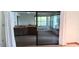 View of the open living area through sliding glass doors, creating a bright and inviting space at 401 Fern Cliff Ave, Temple Terrace, FL 33617