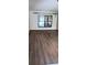Bright living room featuring modern hardwood flooring and a large window at 401 Fern Cliff Ave, Temple Terrace, FL 33617