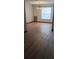 Open-concept living area with hardwood floors and a large window for ample natural light at 401 Fern Cliff Ave, Temple Terrace, FL 33617