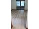 Bright living room with light wood-style flooring and natural light from large windows, creating an open ambiance at 401 Fern Cliff Ave, Temple Terrace, FL 33617