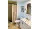 Bathroom featuring a vanity sink, toilet, tiled floors and a shower with curtain at 402 Evergreen Dr, Oldsmar, FL 34677