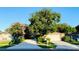 Single story home with lovely landscaping, a two car garage and a large mature shade tree at 402 Evergreen Dr, Oldsmar, FL 34677