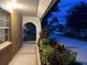 Welcoming front porch with stone archway and vibrant plants adds curb appeal to this lovely home at 402 Evergreen Dr, Oldsmar, FL 34677