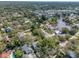 High-angle aerial view of a charming neighborhood with waterfront access and verdant trees at 408 Georgia Ave, Crystal Beach, FL 34681