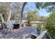 Inviting back deck featuring a fire pit, seating, and charming garden accents at 408 Georgia Ave, Crystal Beach, FL 34681