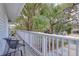 Second story balcony with relaxing chairs overlooking a tree-lined street at 408 Georgia Ave, Crystal Beach, FL 34681
