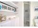 Bright bathroom with shower, storage shelves and decorative nautical themed accessories at 408 Georgia Ave, Crystal Beach, FL 34681