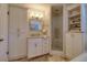 Beautiful bathroom featuring tiled backsplash, glass-enclosed shower, and built-in storage at 408 Georgia Ave, Crystal Beach, FL 34681