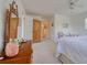 Bright bedroom features a ceiling fan, wood armoire, and doorway to bathroom at 408 Georgia Ave, Crystal Beach, FL 34681