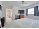 Bright bedroom features a TV, ensuite, and neutral color palette at 408 Georgia Ave, Crystal Beach, FL 34681
