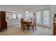 Open dining area with hardwood table set, wood floors, and natural light from the adjacent kitchen at 408 Georgia Ave, Crystal Beach, FL 34681