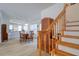 Sunlit dining area features beautiful wood floors, stairs, and access to an open kitchen layout at 408 Georgia Ave, Crystal Beach, FL 34681