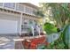 Inviting home exterior with a quaint front porch, lush landscaping, and a light blue front door at 408 Georgia Ave, Crystal Beach, FL 34681