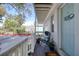 Charming front porch with a light blue door, chair, and plants at 408 Georgia Ave, Crystal Beach, FL 34681