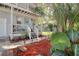 Exterior home featuring a beautiful front porch with lush landscape and a light blue door at 408 Georgia Ave, Crystal Beach, FL 34681