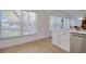 Bright kitchen with stainless steel appliances, natural light, and breakfast bar seating at 408 Georgia Ave, Crystal Beach, FL 34681
