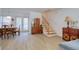 Open-concept living area with wood floors, dining space, and staircase at 408 Georgia Ave, Crystal Beach, FL 34681
