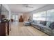 Spacious living room with a gray sectional sofa, wood floors, and open layout at 408 Georgia Ave, Crystal Beach, FL 34681
