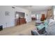 Bright living room featuring wood floors, an open staircase, and a large gray sectional sofa at 408 Georgia Ave, Crystal Beach, FL 34681