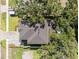 Aerial shot of roof and backyard with pool area, with mature tree and lawn visible at 4114 W Neptune St, Tampa, FL 33629