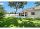 Home exterior showcasing backyard pool, covered patio, and artificial turf at 4114 W Neptune St, Tampa, FL 33629