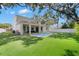 Expansive backyard featuring a rectangular pool and covered patio, perfect for outdoor entertaining at 4114 W Neptune St, Tampa, FL 33629