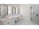 Modern bathroom featuring dual vanities, sleek fixtures, black hardware, and a glass-enclosed shower at 4114 W Neptune St, Tampa, FL 33629