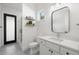 Bathroom featuring a glass enclosed shower, modern vanity with decorative shelves at 4114 W Neptune St, Tampa, FL 33629