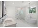 This stylish bathroom offers a standalone tub, a glass enclosed shower, and double vanity at 4114 W Neptune St, Tampa, FL 33629
